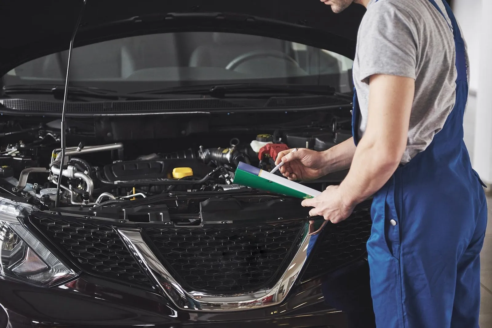 Mechanic working under a car bonnet